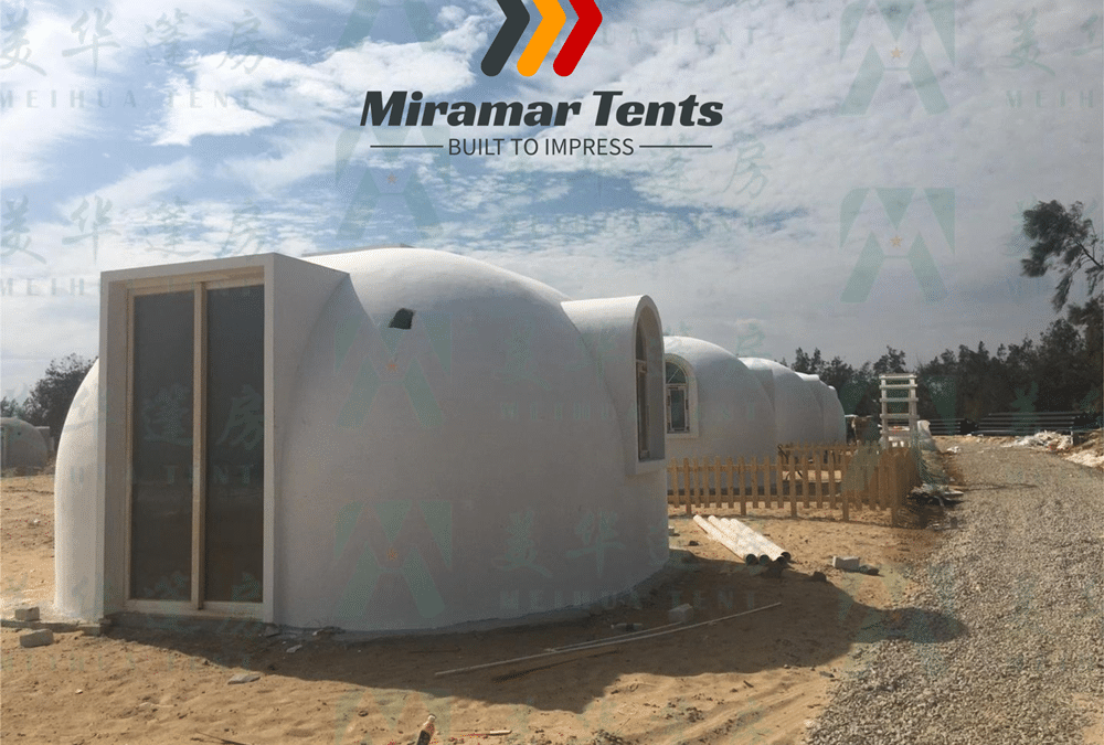 A variety of EPS Bubble Houses set up on grass under a cloudy sky, with the logo "Miramar Tents" overlaying the image, showcasing innovative construction.